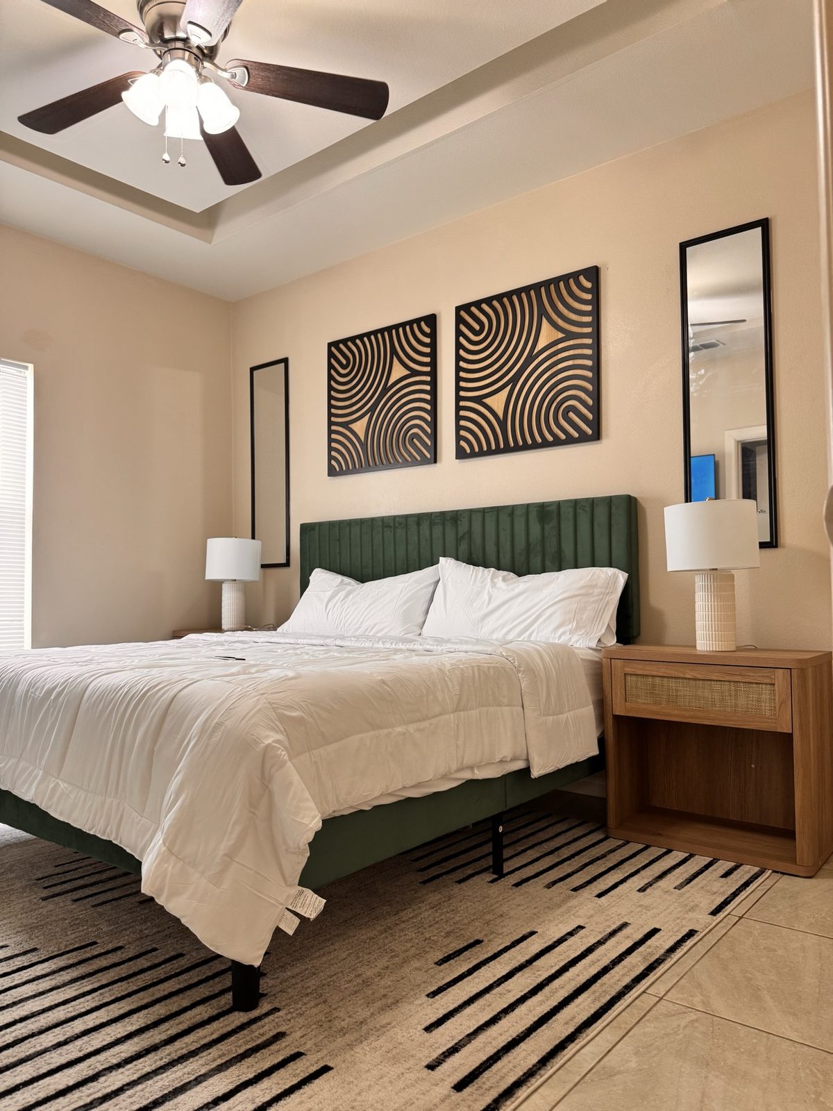 Airbnb emerald bedroom detail with graphic wall art and mirrors