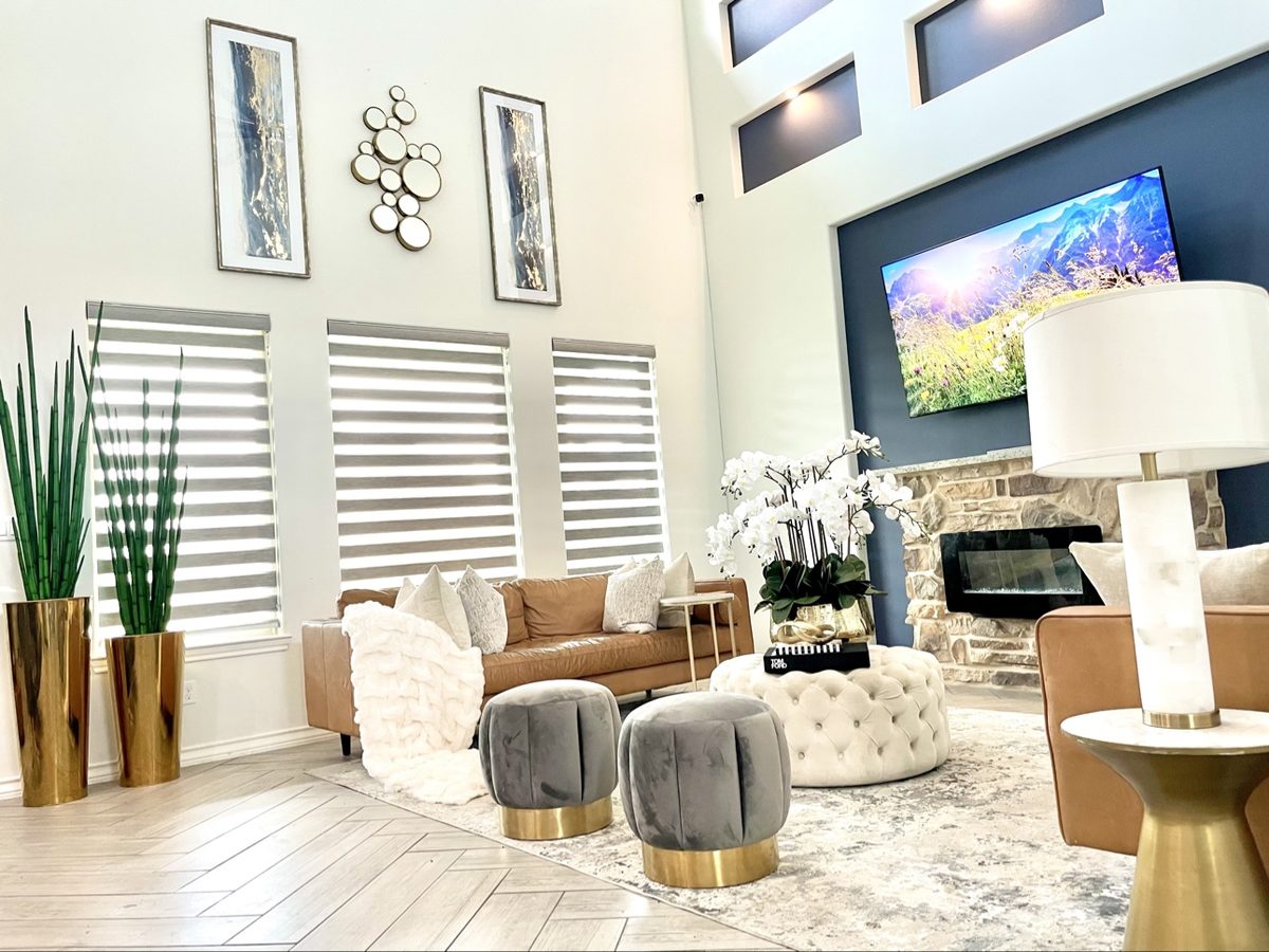 Living room designed by Lubin Akala Design, warm neutral palette with cognac leather sofa