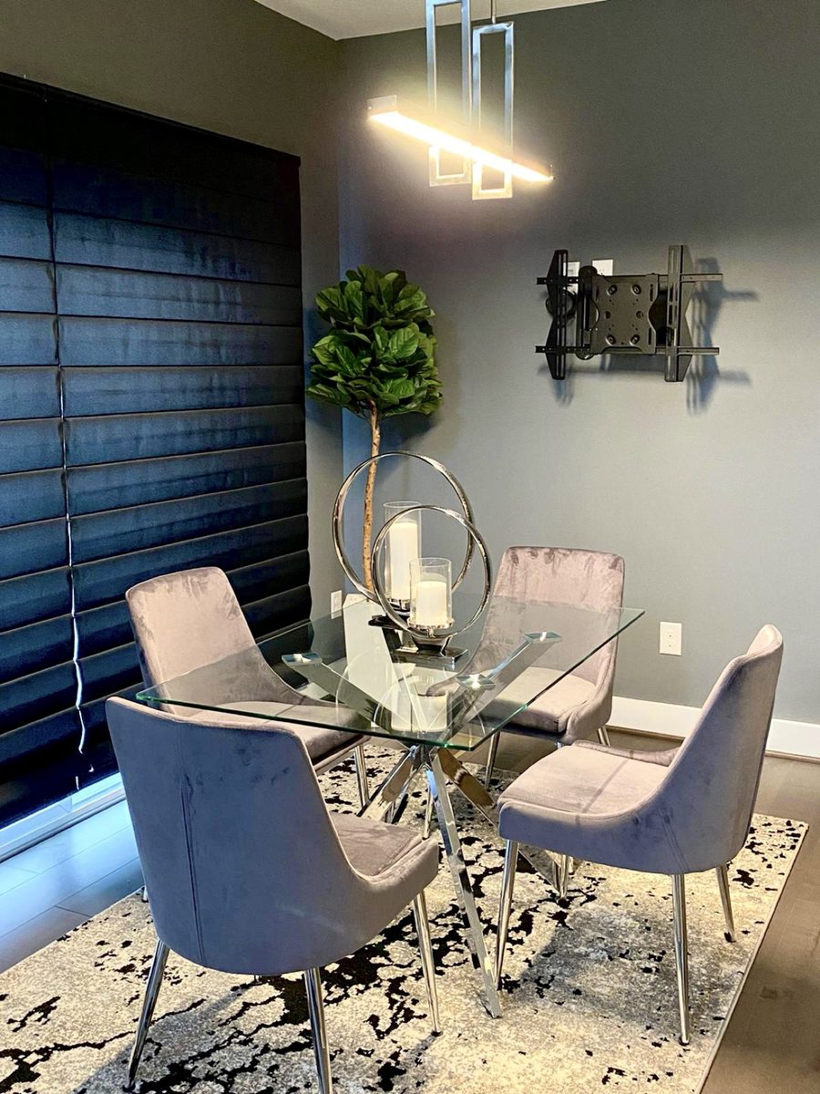 Dining room with glass table and gray velvet chairs