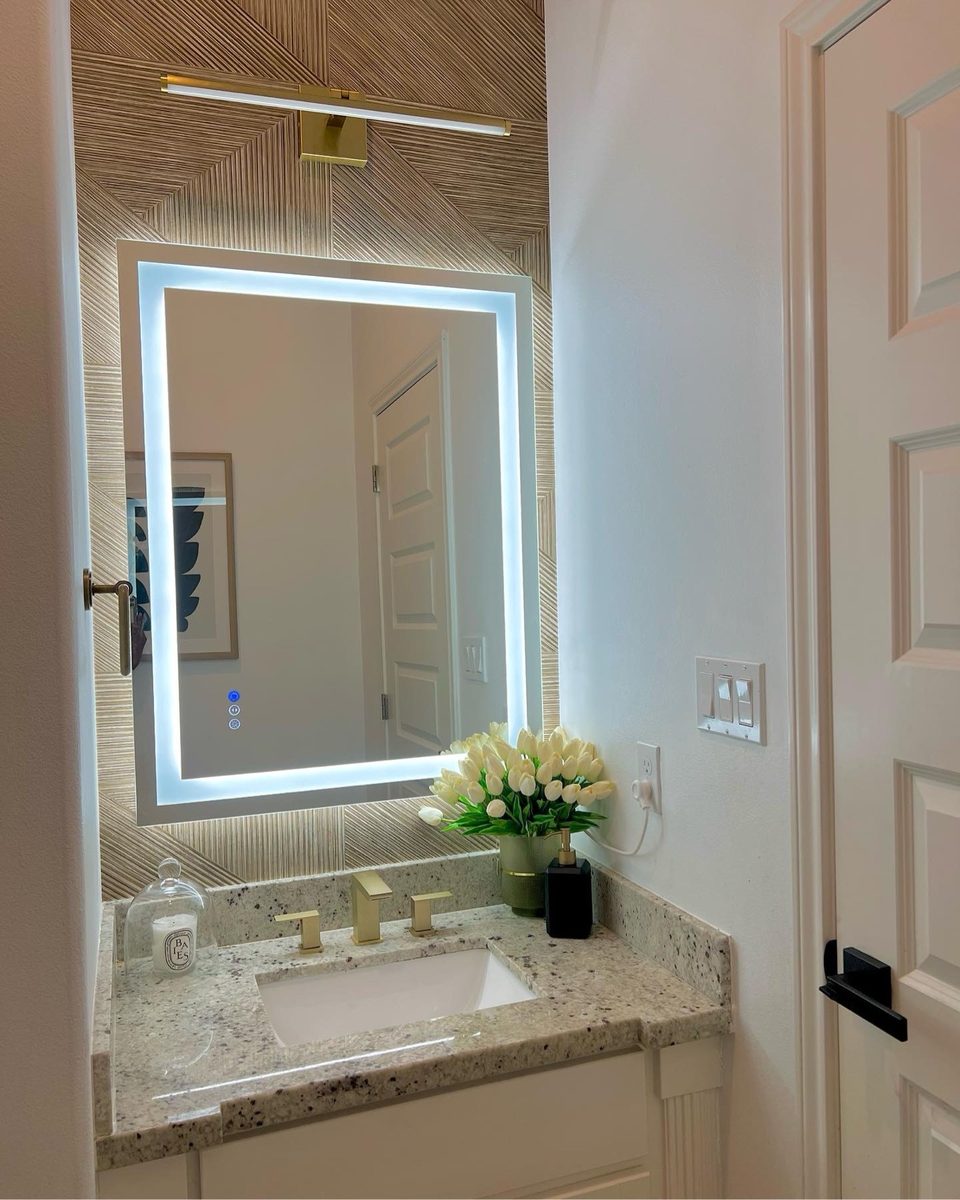 Powder bath with backlit mirror and gold fixtures